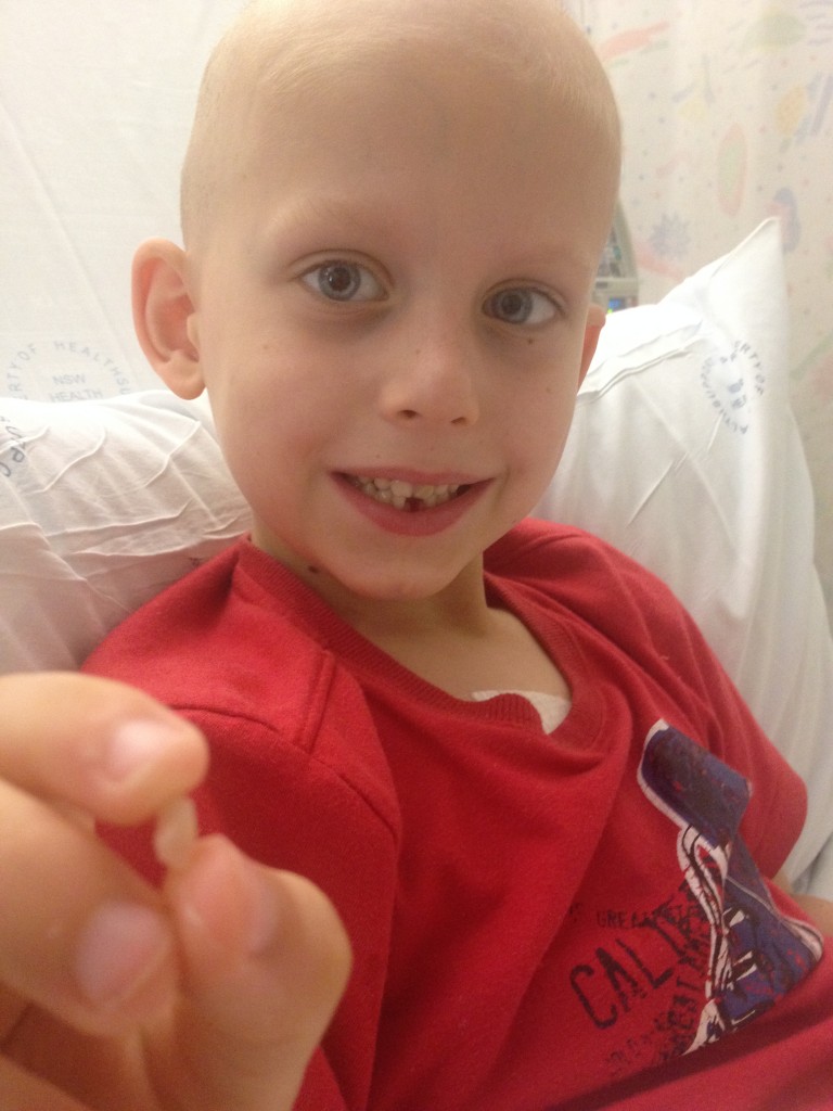 Ethan in hospital with his missing tooth.